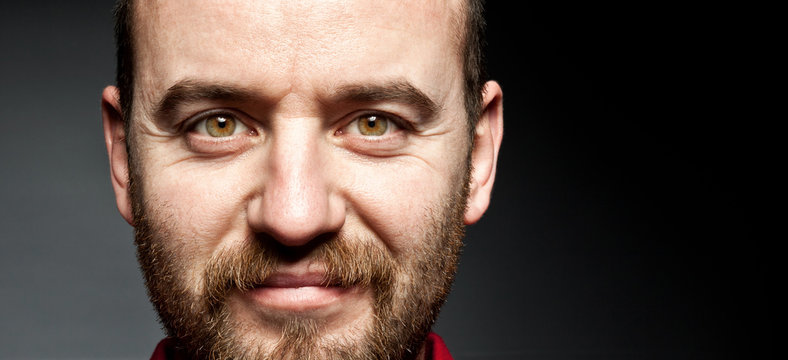 closeup portrait Caucasian man with beard 40 years old dark background