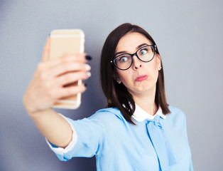 Wall Mural - Funny businesswoman making selfie photo