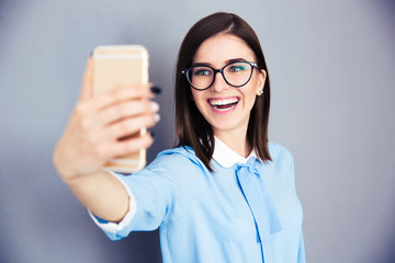 Wall Mural - Laughing businesswoman making selfie photo