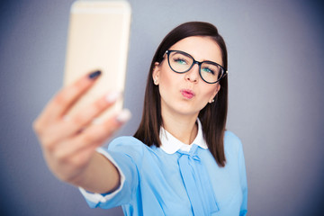 Wall Mural - Funny businesswoman making selfie photo