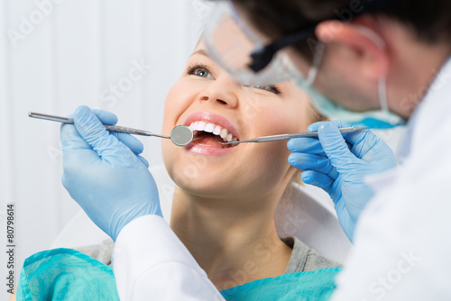 Fotografering Regular dentist visit. Caries cure. Young woman visiting dentist