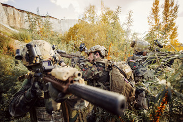 Wall Mural - solders aiming at a target of weapons