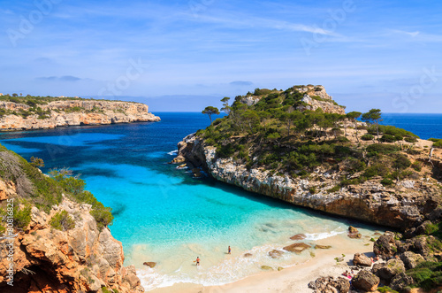 Fotografie, Obraz Couple of people on Cala des Moro beach, Majorca island, Spain