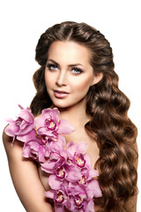 Beauty young woman, luxury long curly hair with orchid flower. H