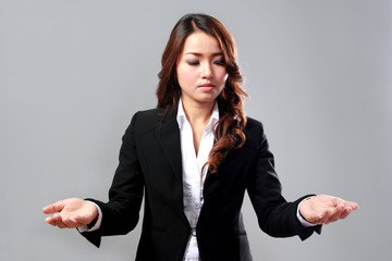 Young businesswoman comparing two items