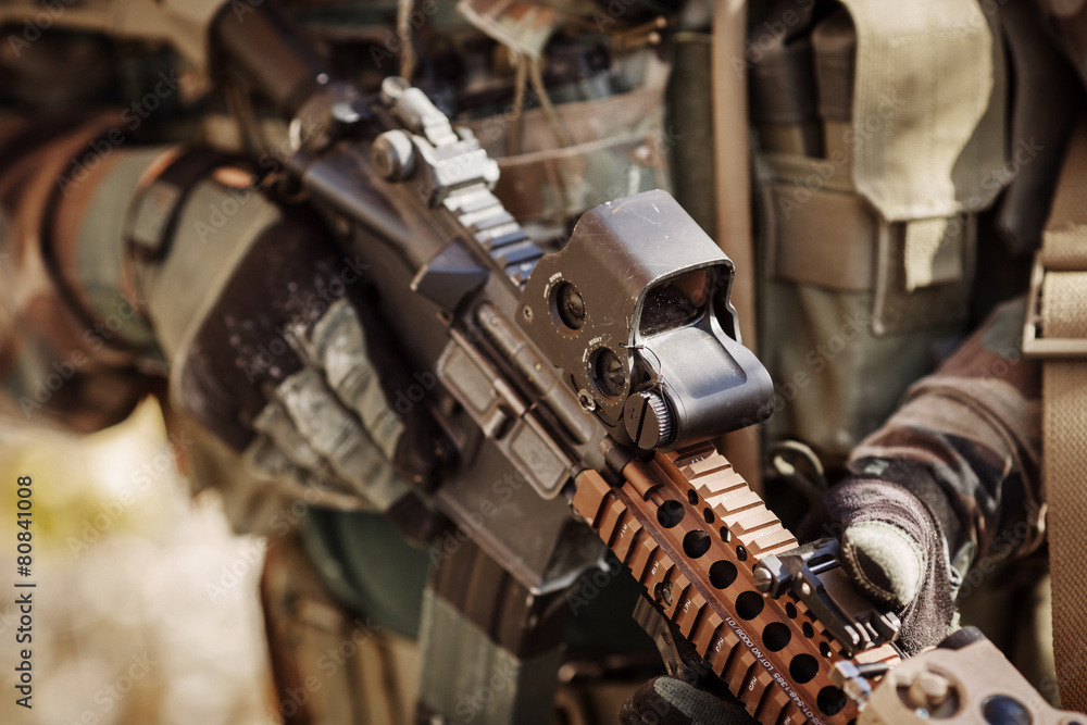 solder in gloves holding assault automatic rifle Stock Photo | Adobe Stock