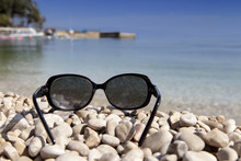 Black Luxury Sun Glasses On A Sandy Beach,