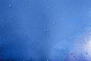 Wall Mural - Water drops on light blue background