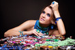 © Serg Zastavkin - Brunette woman and heap of bijouterie