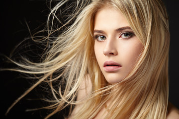 Portrait of blonde girl with fluttering hair