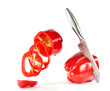 © Ramil Gibadullin - The knife cuts red pepper on a white background