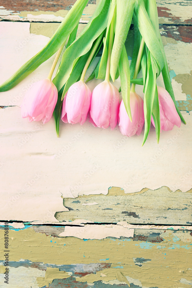 Beautiful pink tulips on wooden background