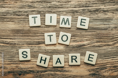 Fotografie, Obraz Share. Time to Share text on a wooden background