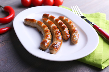 Sticker - Grilled sausages on plate with vegetables on table close up