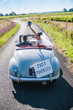 Top view, a newlywed couple is driving a retro car