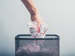 © LoloStock - Hand putting shredded paper in basket