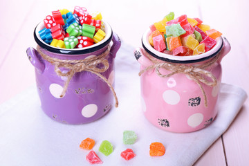 Wall Mural - Sweet candies on color wooden table, closeup