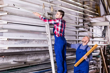 Workers searching for profiles on rack