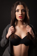 © rvas - Sexy brunette woman with retro black lingerie. Black background.