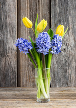 Bouquet Of Fresh Tulips And Hyacinths On Wooden Background