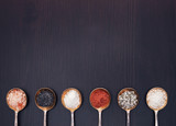 Fototapeta Kuchnia - Salt in vintage metal spoons on a wooden background