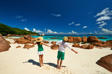 Couple in green having fun on a beach at Seychelles