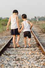 Two Boys Walk On The Railway
