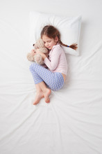 Top View Of Little Cute Girl Sleeping With Teddy Bear
