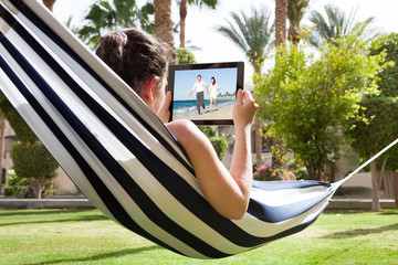 Young Woman Watching Video On Digital Tablet