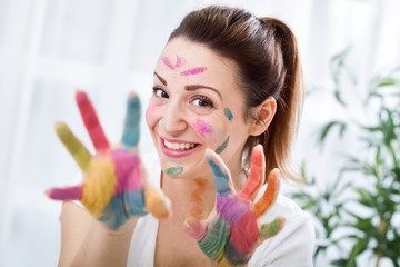 Smiling funny attractive woman with colorful hands