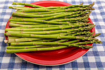 Wall Mural - Fres Raw Asparagus on Red Plate