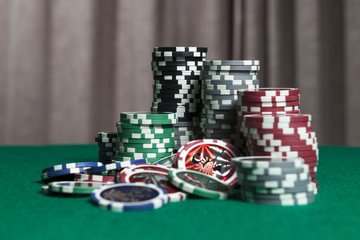 Wall Mural - Colorful poker chips on green background with copy space