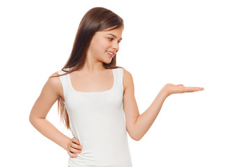 Smiling teenage girl showing open hand palm with copy space