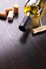 Canvas Print - Bottle of wine with corks and corkscrew on wooden background