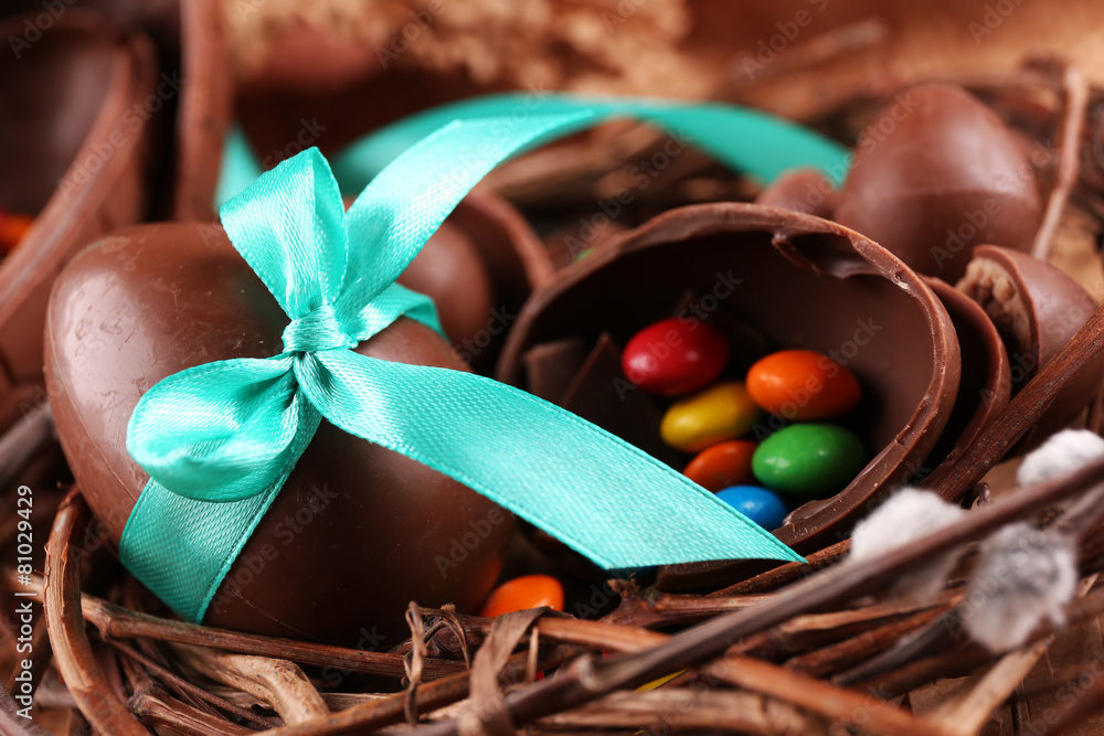 Chocolate Easter eggs in wicker nest, closeup