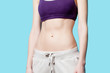 © Masson - Woman showing her abs after weight loss