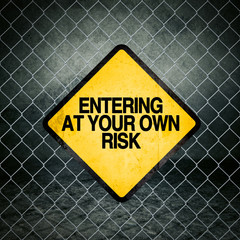 Wall Mural - Entering at Your Own Risk Grunge Yellow Warning Sign