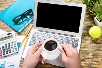 Wall Mural - Laptop. Financial business news online on a laptop with coffee