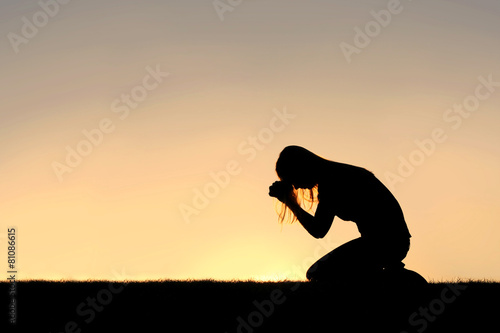 Fotografie, Obraz Christian Woman Sitting Down in Prayer Silhouette