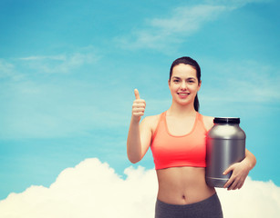 Canvas Print - teenage girl with jar of protein showing thumbs up