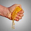 Man's hand squeezes the juice from the orange