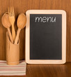 Menu board and wooden spoons and fork