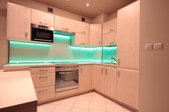 Modern luxury kitchen with green LED lighting
