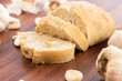 fresh baked loaf of bread with whole cloves of roasted garlic