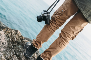 Wall Mural - Traveler with camera standing on coast