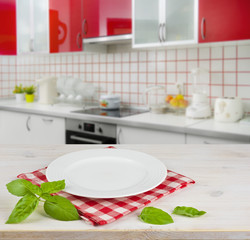 White plate on table placemat over kitchen interior background