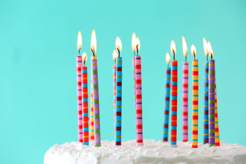 Wall Mural - Birthday cake with candles on color background