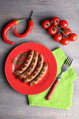 Sticker - Grilled sausages on plate with vegetables on table close up