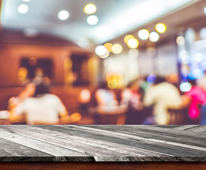 Wall Mural - empty wood table top with restaurant blur with bokeh background