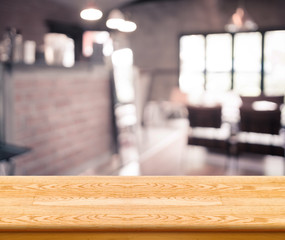 Wall Mural - empty wood table top with coffee shop blur with bokeh background